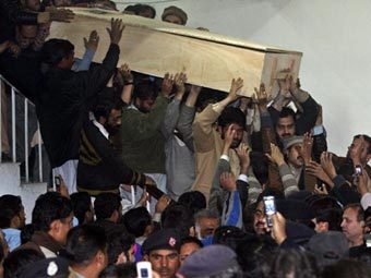 Сторонники Бхутто выносят гроб с ее телом из больницы. Фото AFP